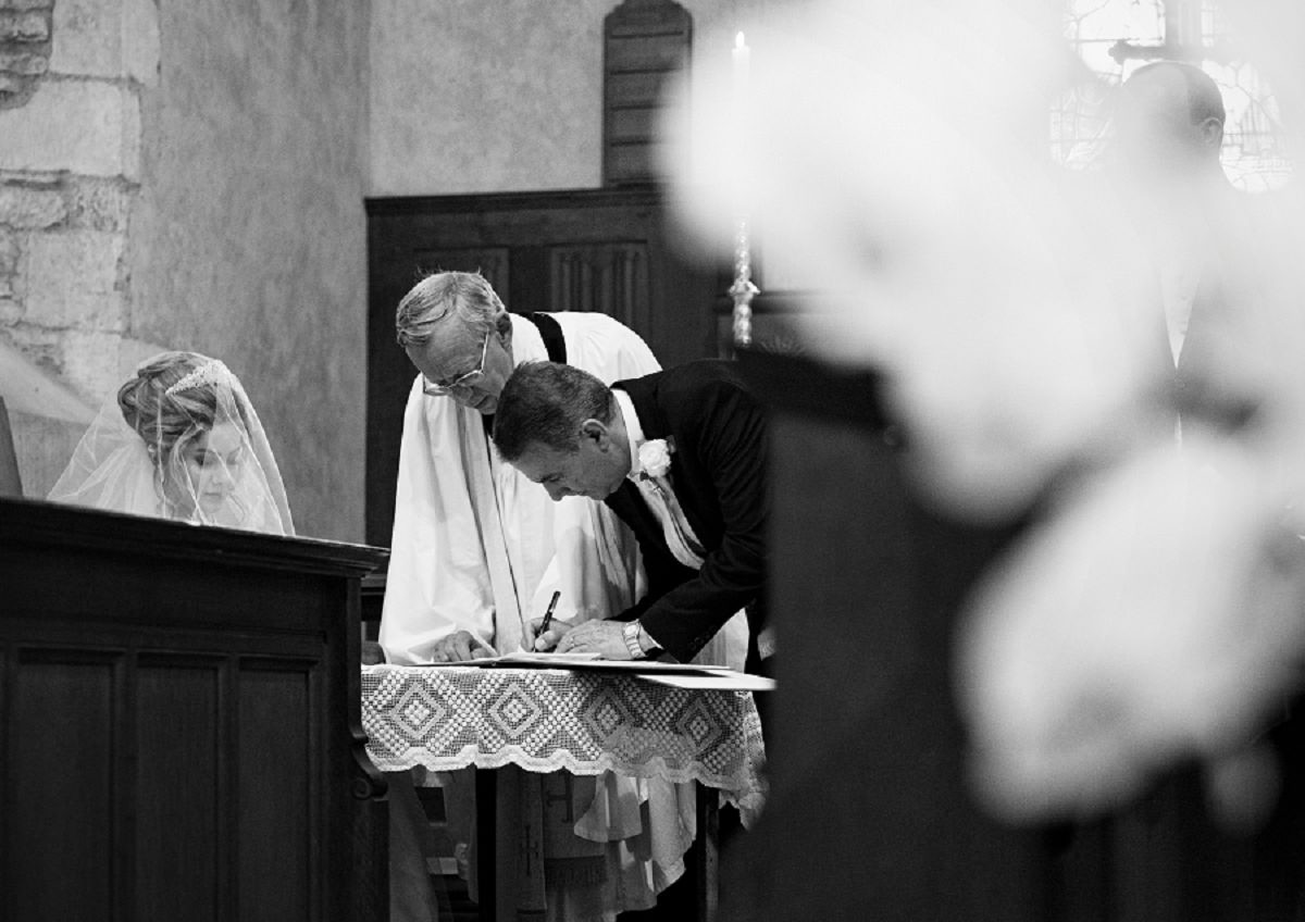 groom signs wedding contract